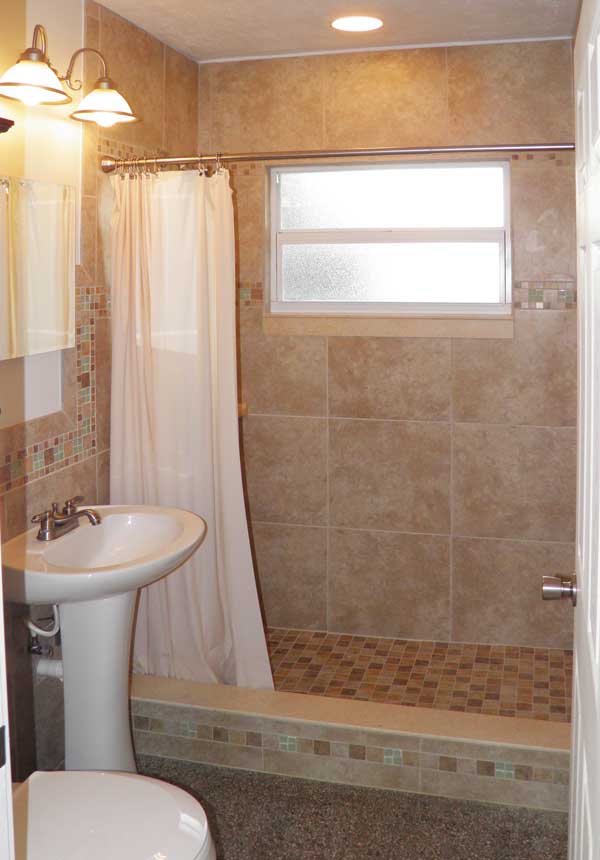All new custom bathroom with floor-to-ceiling tile in shower and plenty of storage.