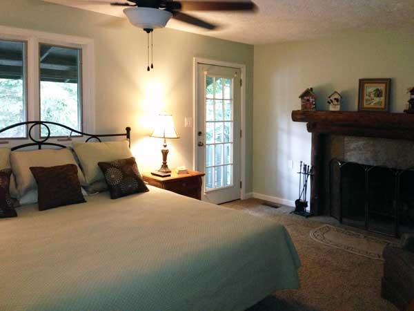 Large master bedroom with fireplace, attached bath and private balcony